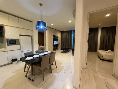 a dining room and living room with a table and chairs at Platinum Klcc by PureStay in Kuala Lumpur