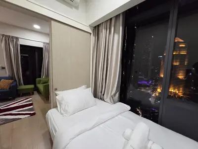 a hotel room with a bed and a large window at KL Star Residance KLCC by Nexus 111 in Kuala Lumpur