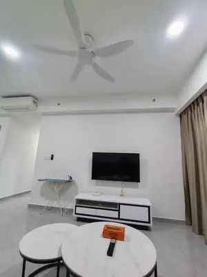 a living room with two tables and a flat screen tv at Agile Bukit Bintang TRX by AR in Kuala Lumpur