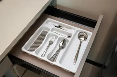 a white sink with utensils in a drawer at Opus Residences KL by PILLOWTALKS in Kuala Lumpur