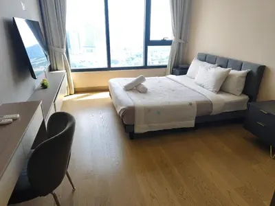 a bedroom with a bed and a desk and a window at One Bedroom Apartment Lucentia Residence in Kuala Lumpur