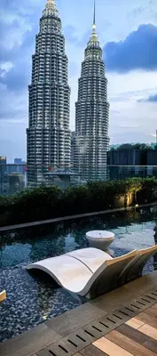 two tall skyscrapers in the background of a city at Star residence in Kuala Lumpur