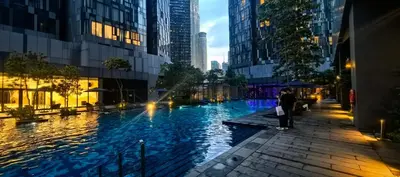 a woman standing next to a river in a city at Star residence in Kuala Lumpur