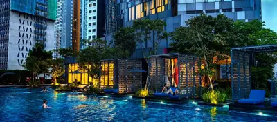 a pool in the middle of a city with people in it at Star residence in Kuala Lumpur