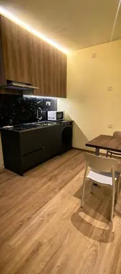 a kitchen with a table and a wooden floor at summer suite, KLCC in Kuala Lumpur