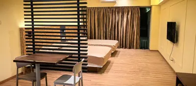a bedroom with a bed and a table and a desk at summer suite, KLCC in Kuala Lumpur