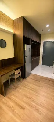 a kitchen with a refrigerator and a table and a chair at summer suite, KLCC in Kuala Lumpur