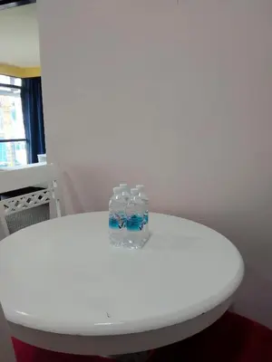 two water bottles sitting on top of a white table at Krish Apartment At Times Square in Kuala Lumpur