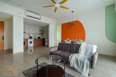 a living room with a couch and a table at The Ooak Suites Kiara 163 by Five Senses in Kuala Lumpur