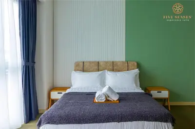 a bedroom with a bed with a tray of food on it at The Ooak Suites Kiara 163 by Five Senses in Kuala Lumpur