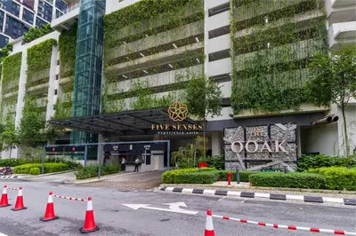 a street with orange cones in front of a building at The Ooak Suites Kiara 163 by Five Senses in Kuala Lumpur