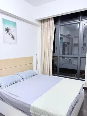 a white bed in a room with a window at Sea Homestay in Kuala Lumpur