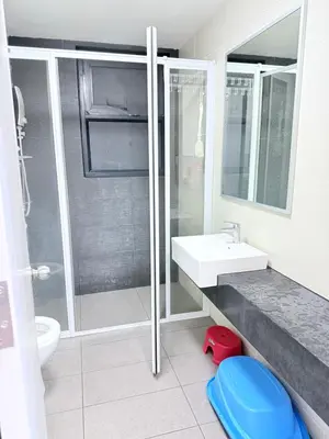 a bathroom with a shower and a sink and a toilet at Sea Homestay in Kuala Lumpur