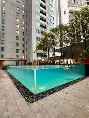 a swimming pool in front of some tall buildings at 2 Bedroom Apartment Near KLCC 5 minutes Walk in Kuala Lumpur