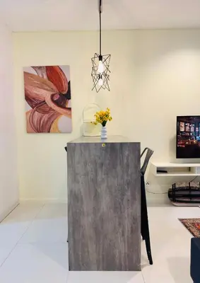 a room with a table with a vase of flowers on it at 2 Bedroom Apartment Near KLCC 5 minutes Walk in Kuala Lumpur