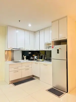 a kitchen with white cabinets and a refrigerator at 2 Bedroom Apartment Near KLCC 5 minutes Walk in Kuala Lumpur