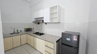 a kitchen with a black refrigerator and cabinets at VUE Residence - City View Apartment as Home Stay in Kuala Lumpur