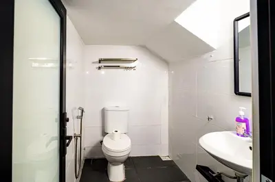 a white bathroom with a toilet and a sink at Seputeh 2Sty House - 10 min to MidValley KL Gateway Bangsar in Kuala Lumpur