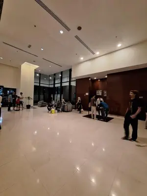 a lobby with people standing around in a building at KL Residences at Berjaya Times Square in Kuala Lumpur