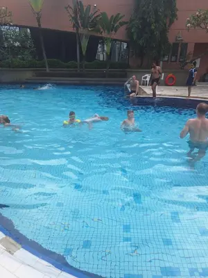 a group of people swimming in a swimming pool at KL Residences at Berjaya Times Square in Kuala Lumpur