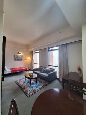 a living room with a couch and a table at KL Residences at Berjaya Times Square in Kuala Lumpur
