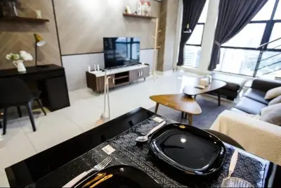 a living room with a couch and a table with a sink at BMC Arte Mont Kiara in Kuala Lumpur