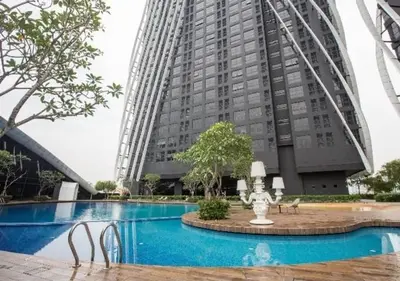 a large building with a swimming pool in front of a building at BMC Arte Mont Kiara in Kuala Lumpur