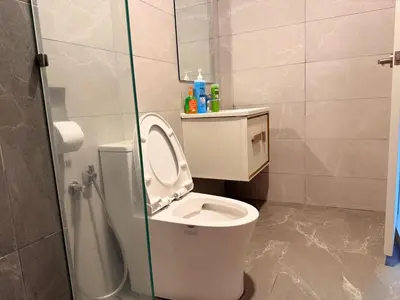 a bathroom with a toilet with a glass shower stall at MH Rest House at Majestic Residence in Kuala Lumpur