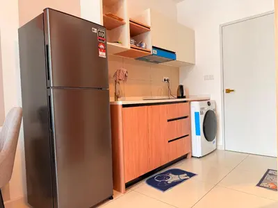 a kitchen with a stainless steel refrigerator and a dishwasher at MH Rest House at Majestic Residence in Kuala Lumpur