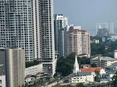 a city skyline with tall buildings and a church at Robertson S15 KLCC Alor Street Bukit Bintang 5Pax in Kuala Lumpur