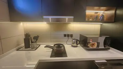 a kitchen counter with a coffee maker and a microwave at KL Nice Condo in Kuala Lumpur
