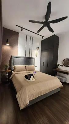 a bedroom with a large bed with a ceiling fan at KL Nice Condo in Kuala Lumpur