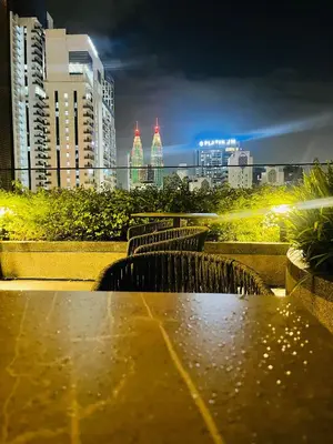 a table with a view of a city at night at Majestic Residence Klcc by Apple in Kuala Lumpur