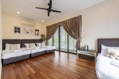 a living room with two beds and a ceiling fan at The Noble Bungalow, 18pax 5R4B near Datuk Keramat, KL Pavilion in Kuala Lumpur