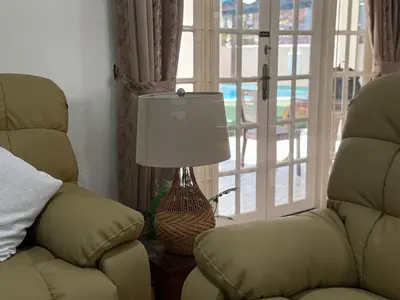 a living room with a lamp and a chair at Grand Luxe Bangalow 8BR, Ampang Utama Park, LRT in Ampang