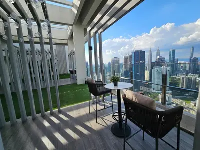 a balcony with a table and chairs and a view of the city at Bukit Bintang Agile 400m to TRX DualKey 2-7pax in Kuala Lumpur