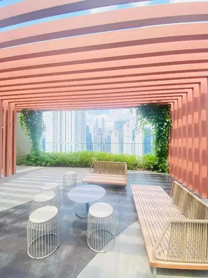 a patio with tables and chairs in a building at Majestic Residence KLCC by Nexus Suites in Kuala Lumpur