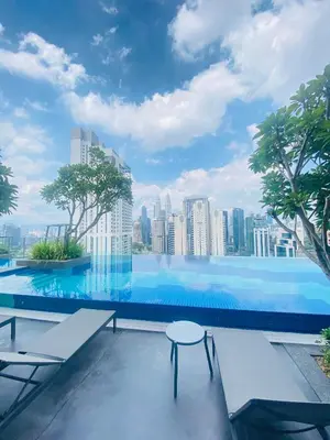 a swimming pool with a city skyline in the background at Majestic Residence KLCC by Nexus Suites in Kuala Lumpur