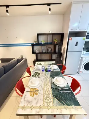 a dining room with a table and a couch at CozyNest KLCC at Mercu Summer Suites in Kuala Lumpur