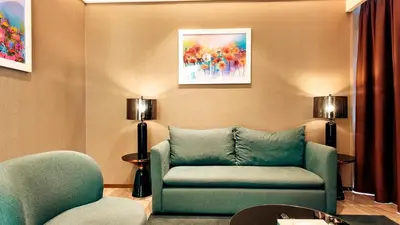 a living room with a couch and a chair at Imperial Residence KLCC - MJ Home in Kuala Lumpur