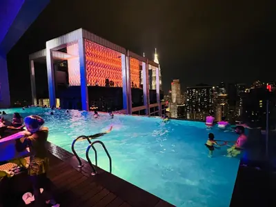 a group of people in a swimming pool at night at Peace Pavilion At Platinum in Kuala Lumpur
