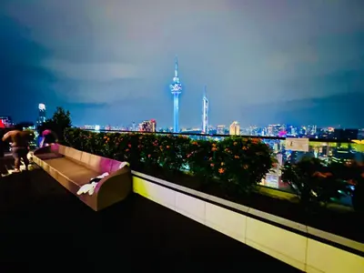 a bench on top of a building with a city skyline at Peace Pavilion At Platinum in Kuala Lumpur
