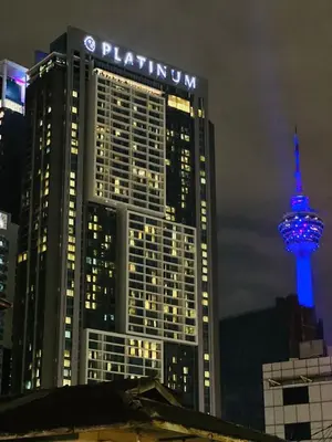 a tall building with a blue lit up tower at Peace Pavilion At Platinum in Kuala Lumpur