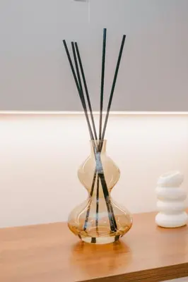 a glass vase with sticks in it on a table at Modern Cozy Home Kuala Lumpur, Agile Residence Bukit Bintang in Kuala Lumpur