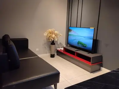 a living room with a flat screen tv on a entertainment center at Unitopia near KLCC pavillion in Kuala Lumpur