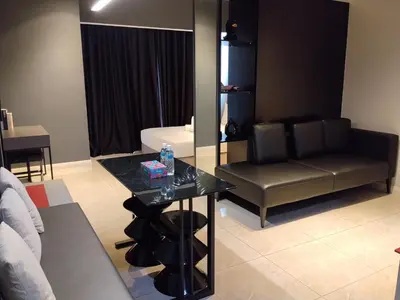 a living room with a table and a couch at Unitopia near KLCC pavillion in Kuala Lumpur