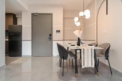a dining room with a table and chairs and a refrigerator at Grand 2BR Agile Bukit Bintang BY RumaBnB in Kuala Lumpur