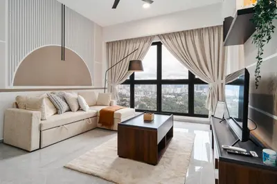 a living room with a couch and a tv at Grand 2BR Agile Bukit Bintang BY RumaBnB in Kuala Lumpur