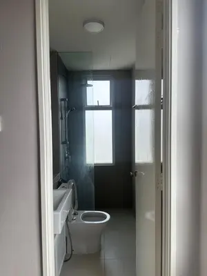 a bathroom with a toilet and a sink and a window at Desa green apartment in Kuala Lumpur