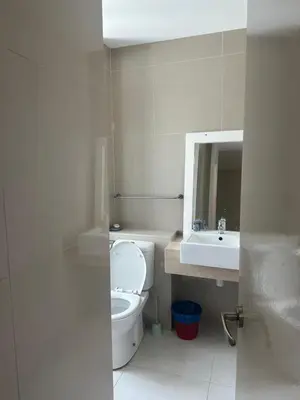 a bathroom with a toilet and a sink and a mirror at Desa green apartment in Kuala Lumpur